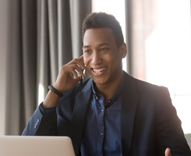 Young businessman smiling while on the phone with an international call center representative