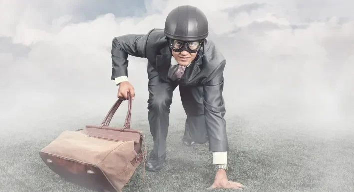 man climbing a mountain with briefcase 