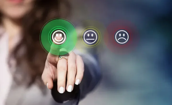 Three faces - a green happy face, a yellow neutral face and a red sad face. The green face is being selected