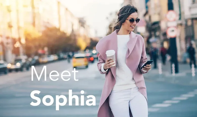 A woman stands in a street, wearing a pink coat, sunglasses and holding a coffee. Text reads "Meet Sophia"