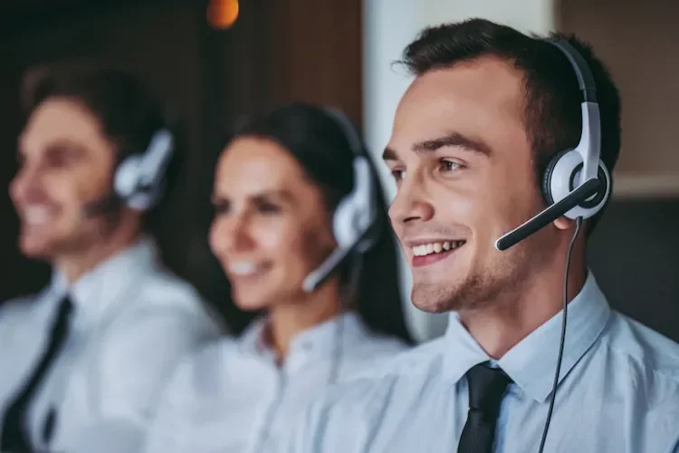 3 people smiling, wearing headsets