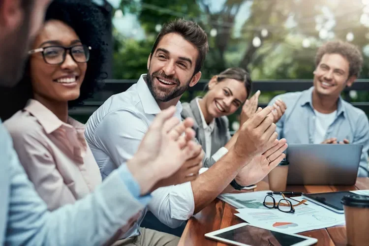 A group of people smiling and clapping