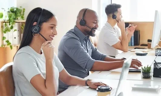 People working with headsets at an office