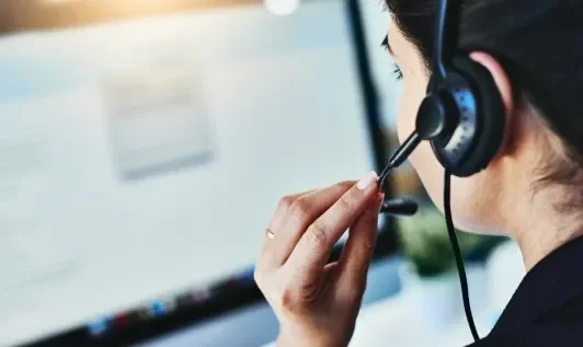 Person Speaking into Headset While Working