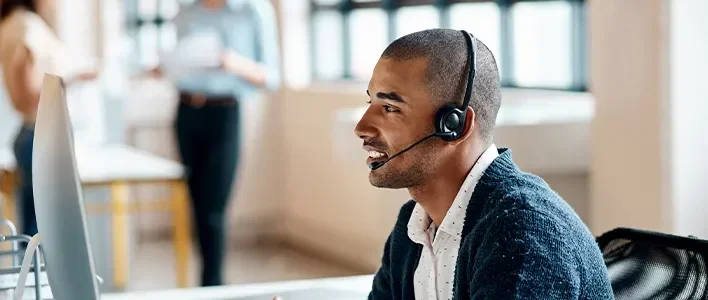 Man Using Computer and Headset