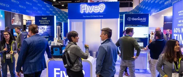 Crowd interacting at a trade show booth with "Five9" signage in a vibrant setting.