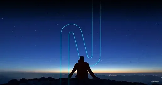 Silhouette of a person sitting on a mountain at twilight, with a blue glowing design.