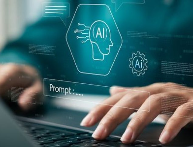 Hands typing on a laptop with AI graphics in the background.