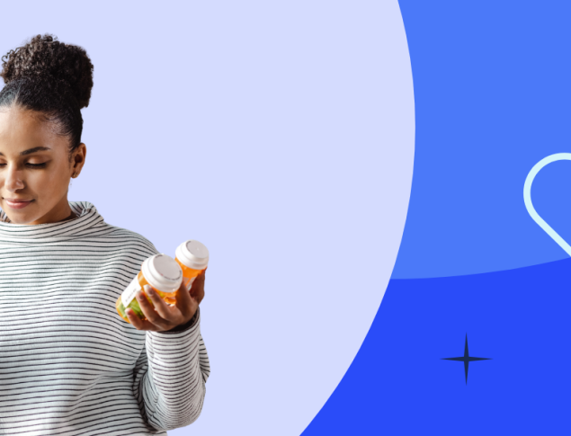 Woman in a gray sweater holding a phone and containers of medication against a blue background.